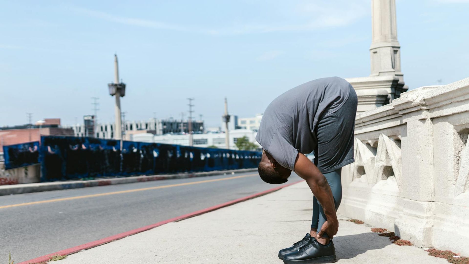 A focused man performing a bodyweight exercise in a minimalist, well-lit space.